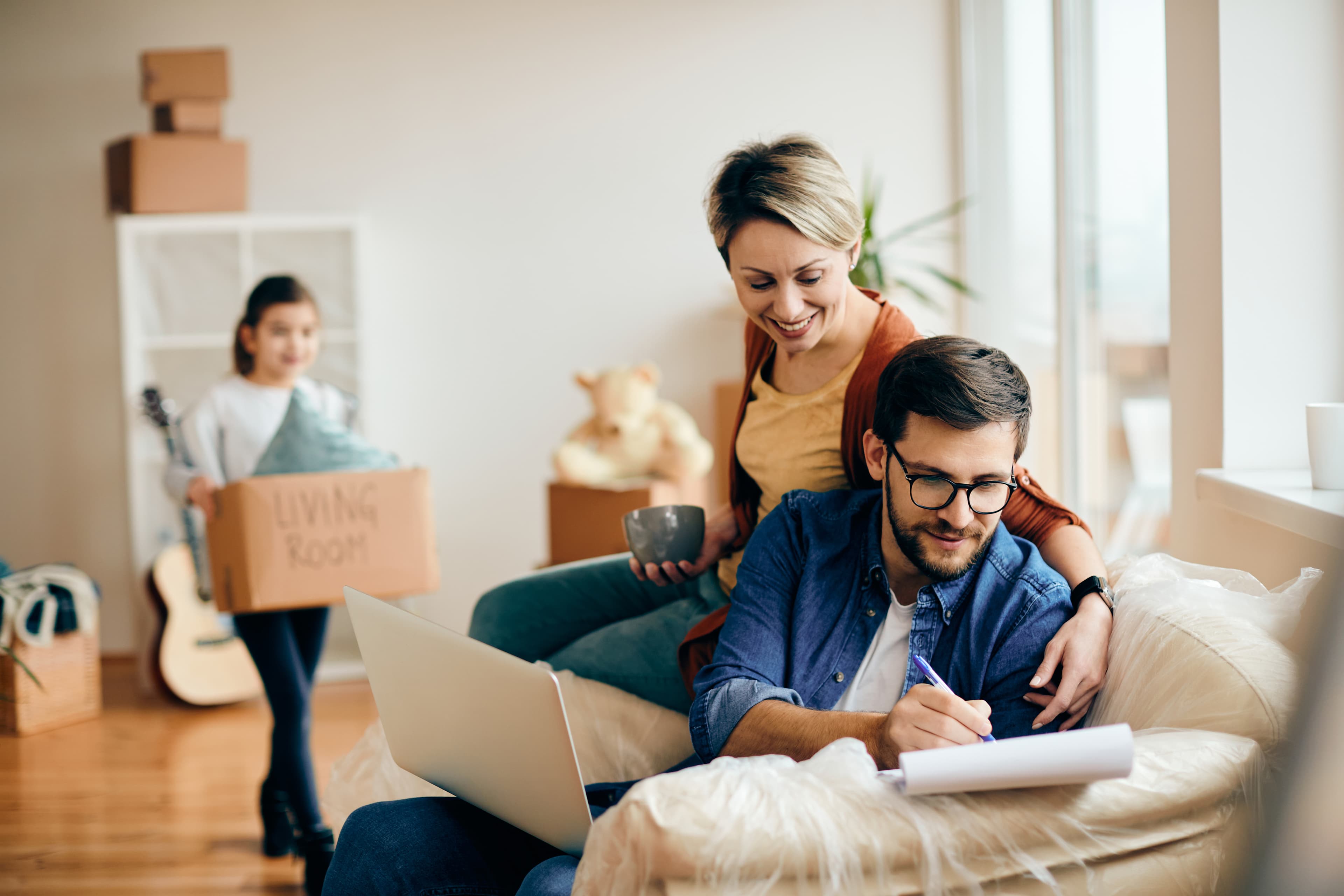 happy-parents-with-daughter-relocating-into-new-apartment