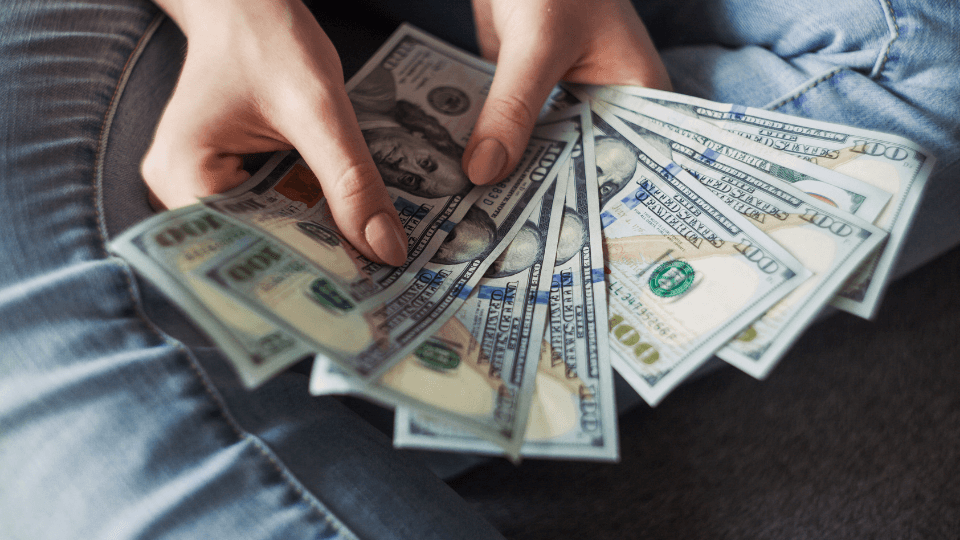 Woman holding a large amount of cash